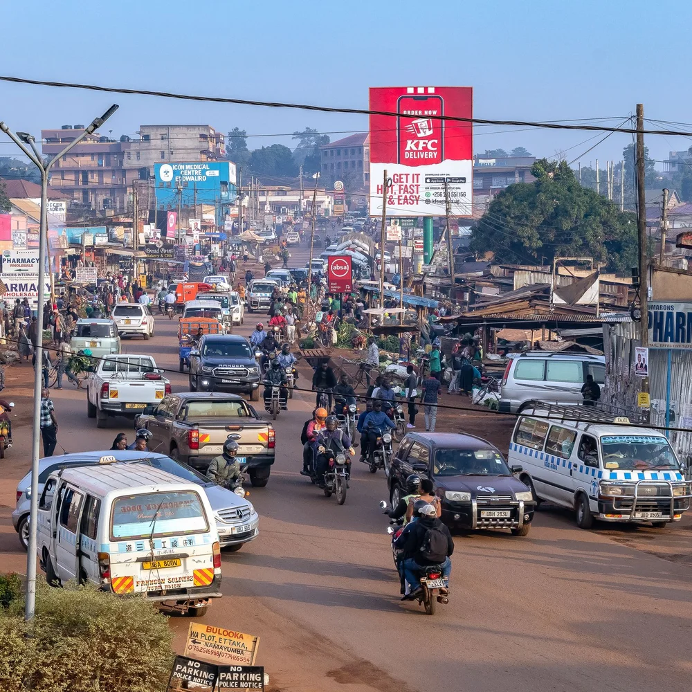 A Kampala street with local transport and everyday city activity